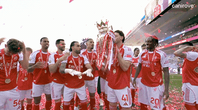 A Group Of Soccer Players Celebrate With A Trophy And Confetti GIF