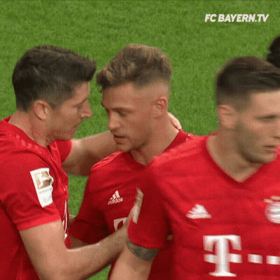 A Group Of Soccer Players From Fc Bayern.tv Are Hugging GIF