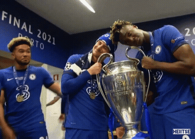A Group Of Soccer Players Holding A Trophy In Front Of A Wall That Says Final 2021 GIF