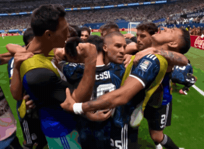 A Group Of Soccer Players Huddle Around A Player With Messi On The Back Of His Jersey GIF