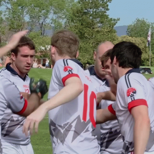 A Group Of Soccer Players Huddle Together With One Wearing The Number 10 GIF