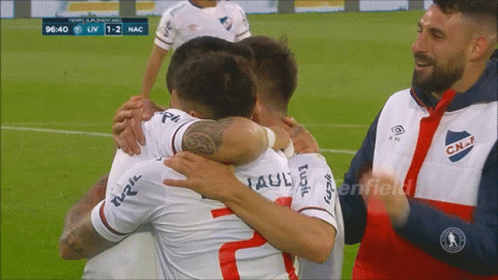 A Group Of Soccer Players Hugging Each Other With The Number 2 On The Back Of Their Jersey GIF