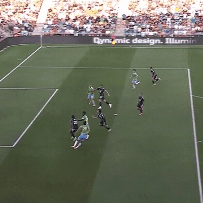 A Group Of Soccer Players On A Field With A Dynamic Design Sign In The Background GIF