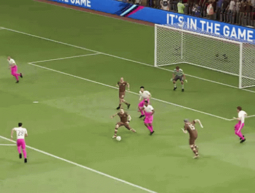 A Group Of Soccer Players On A Field With A Goalie In The Background GIF