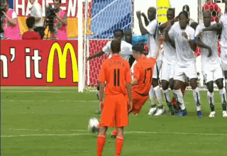 A Group Of Soccer Players On A Field With A Mcdonald 'S Sign Behind Them GIF