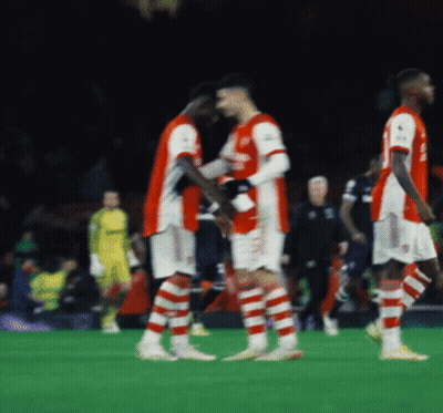A Group Of Soccer Players On A Field With One Wearing A Jersey That Says ' Arsenal ' GIF
