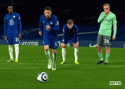 a group of soccer players on a field with one wearing a shirt that says 26