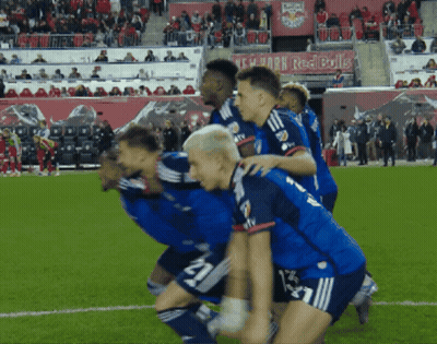 A Group Of Soccer Players On The Field With A Red Bulls Banner In The Background GIF
