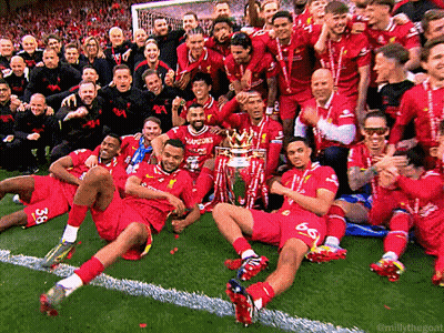 A Group Of Soccer Players Posing For A Photo With A Trophy GIF