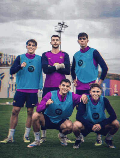 A Group Of Soccer Players Posing For A Picture With One Wearing A Nike Vest That Says Spotify GIF