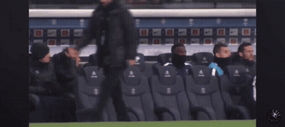 A Group Of Soccer Players Sit In A Stadium Watching A Game GIF