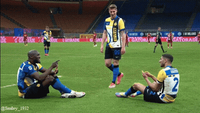 A Group Of Soccer Players Sitting On The Field With One Wearing A Number 2 Jersey GIF