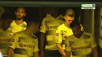 A Group Of Soccer Players Wearing Evonik Jerseys Stand In A Locker Room GIF