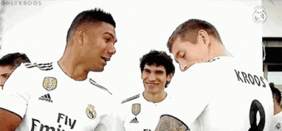 A Group Of Soccer Players Wearing Fly Emirates Jerseys Are Standing Next To Each Other And Smiling . GIF
