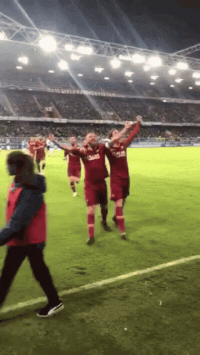 A Group Of Soccer Players Wearing Qatar Jerseys Celebrate GIF