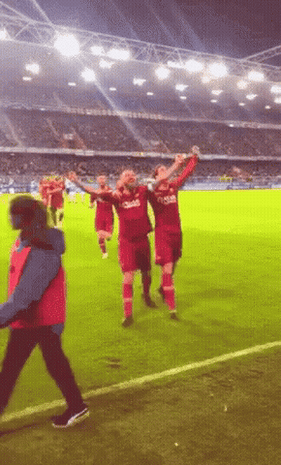 A Group Of Soccer Players Wearing Qatar Jerseys Celebrate GIF