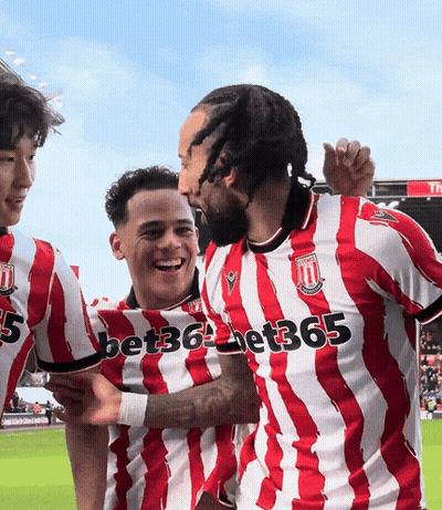 A Group Of Soccer Players Wearing Red And White Striped Jerseys With Bet365 Written On The Front GIF