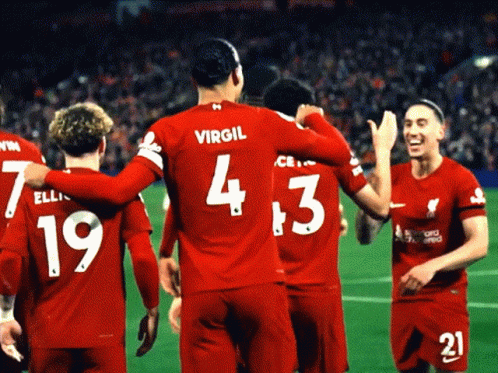 A Group Of Soccer Players Wearing Red Jerseys With The Number 4 And 3 On Them GIF