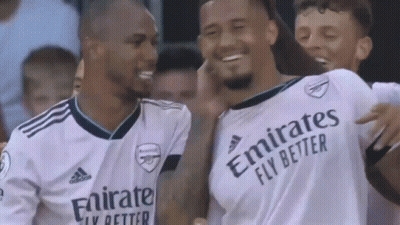 A Group Of Soccer Players Wearing White Jerseys With Emirates Fly Better Written On Them Are Standing Next To Each Other GIF