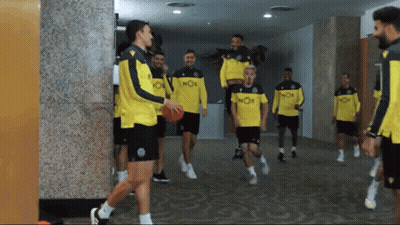 A Group Of Soccer Players Wearing Yellow Jerseys With Nos On Them GIF