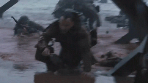 A Group Of Soldiers Are Crawling Through A Muddy River GIF