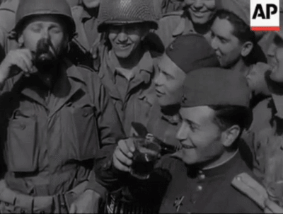 A Group Of Soldiers Are Gathered Around A Man Holding A Coca Cola Cup GIF