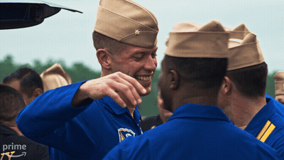 A Group Of Soldiers Are Gathered In Front Of A Car With The Word Prime On The Bottom Right GIF