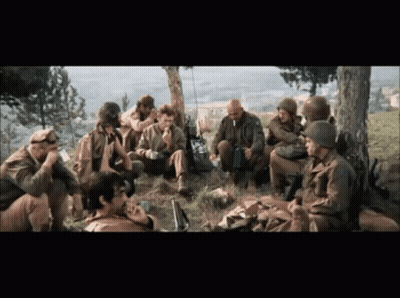 A Group Of Soldiers Are Gathered Under A Tree Talking GIF