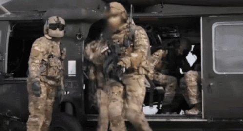 A Group Of Soldiers Are Getting Out Of A Military Helicopter GIF