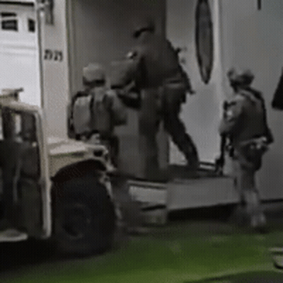 A Group Of Soldiers Are Getting Out Of An Ambulance In A Black And White Photo . GIF