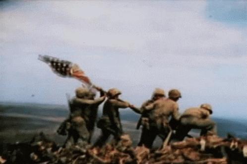 A Group Of Soldiers Are Holding An American Flag On Top Of A Hill GIF