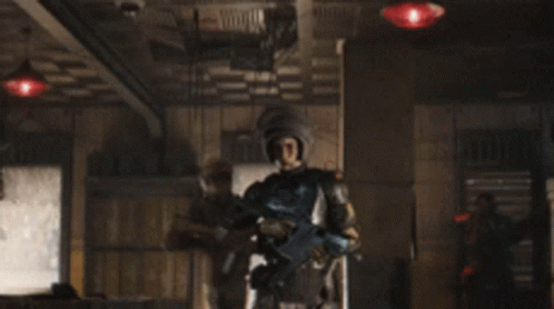 A Group Of Soldiers Are Holding Guns In A Dark Room . GIF