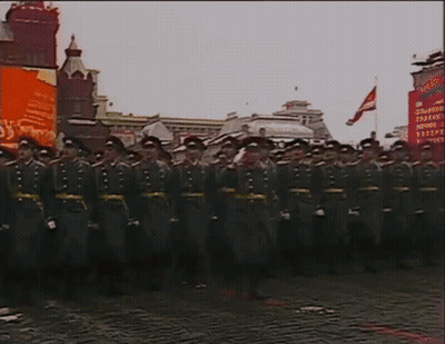 A Group Of Soldiers Are Marching In Front Of A Sign That Says ' Soviet Union ' On It GIF