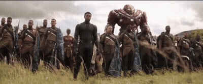 A Group Of Soldiers Are Standing In A Field With A Robot In The Background . GIF