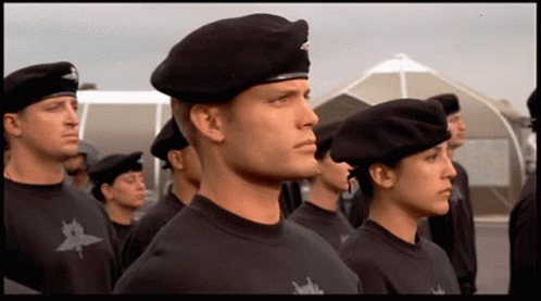 A Group Of Soldiers Are Standing In A Line With One Wearing A Beret GIF