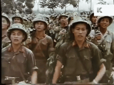 A Group Of Soldiers Are Standing In A Line With The Letter K Visible In The Corner GIF