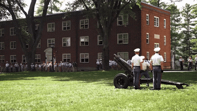 A Group Of Soldiers Are Standing In Front Of A Building GIF