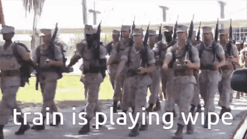 A Group Of Soldiers Marching In A Parade With The Words `` Train Is Playing Wipe '' On The Bottom . GIF