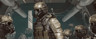 A Group Of Soldiers Wearing Gas Masks And Helmets Are In A Room GIF