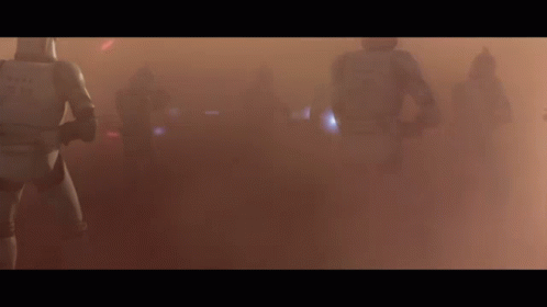 A Group Of Storm Trooper Soldiers Are Walking Through A Foggy Field . GIF