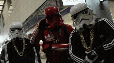 A Group Of Stormtroopers Wearing Adidas Jackets And Gold Chains GIF