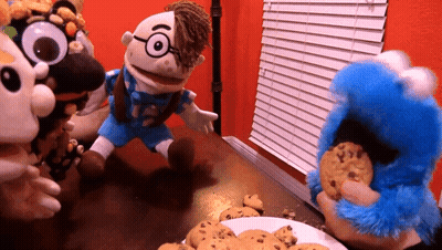 A Group Of Stuffed Animals Are Playing With Cookies On A Table GIF