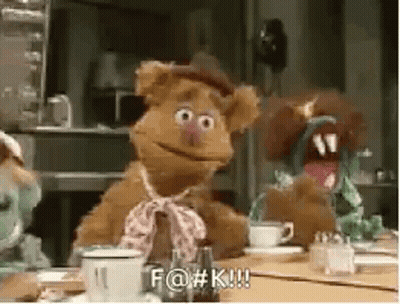 A Group Of Stuffed Animals Are Sitting At A Table With A Cup Of Coffee And A Teapot . GIF