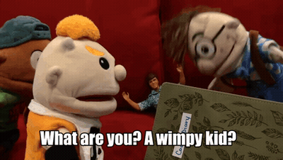 A Group Of Stuffed Animals Are Standing Around A Book That Says " What Are You ? A Wimpy Kid " GIF