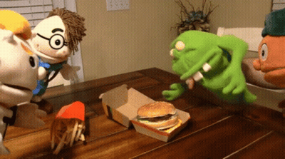 A Group Of Stuffed Animals Sitting Around A Table With A Mcdonald 'S Hamburger And French Fries GIF