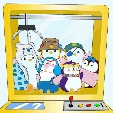 A Group Of Stuffed Penguins Are In A Machine GIF