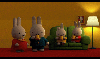 A Group Of Stuffed Rabbits Are Sitting On A Couch Drinking Coffee GIF