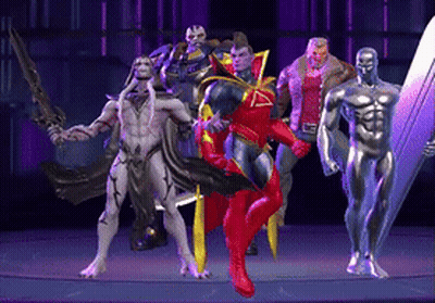 A Group Of Superhero Figures Standing Next To Each Other On A Stage GIF