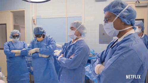 A Group Of Surgeons In An Operating Room With A Netflix Logo GIF