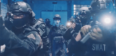 A Group Of Swat Officers In A Dark Room GIF